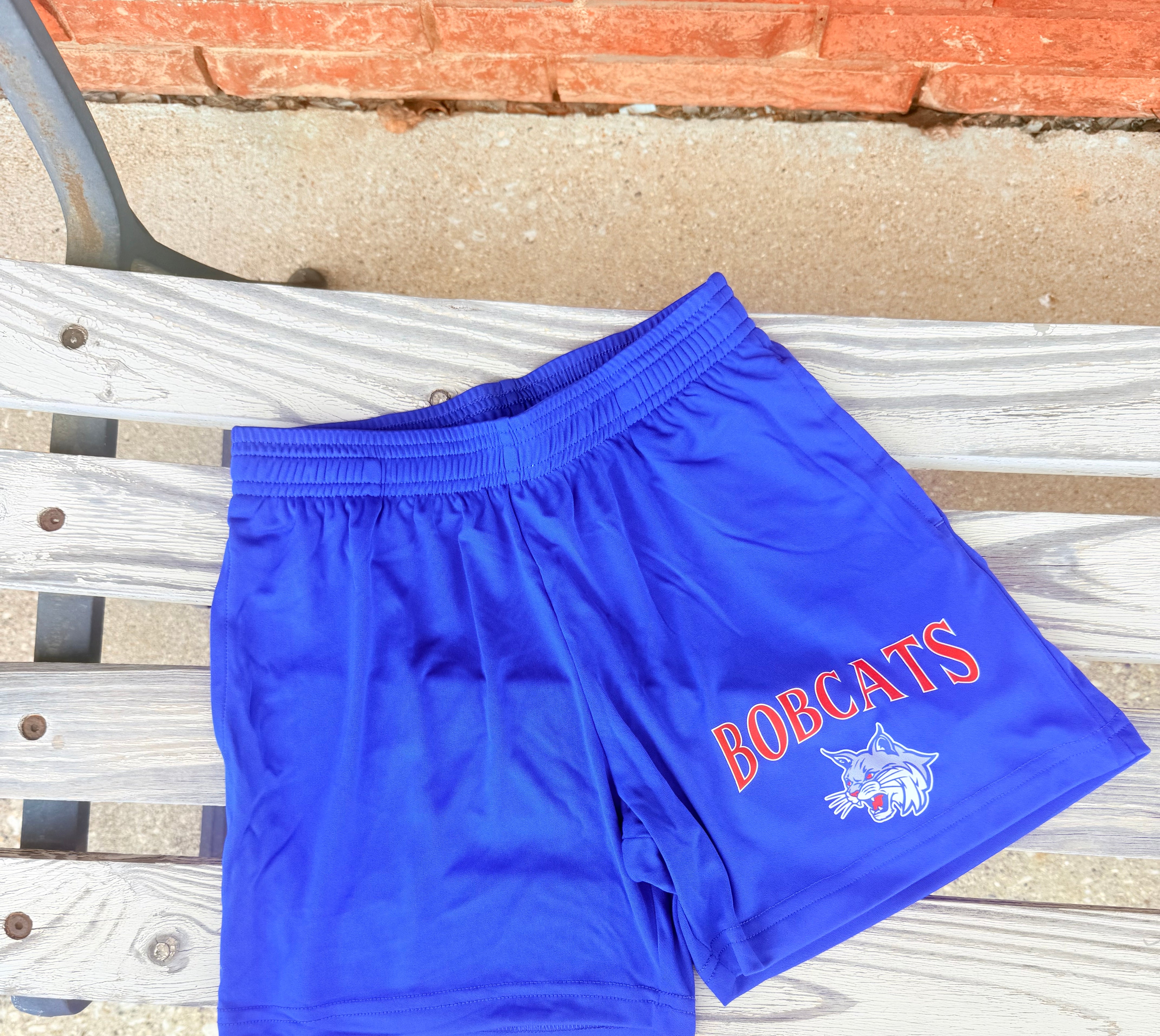 Blue athletic shorts with 'Bobcats' text.