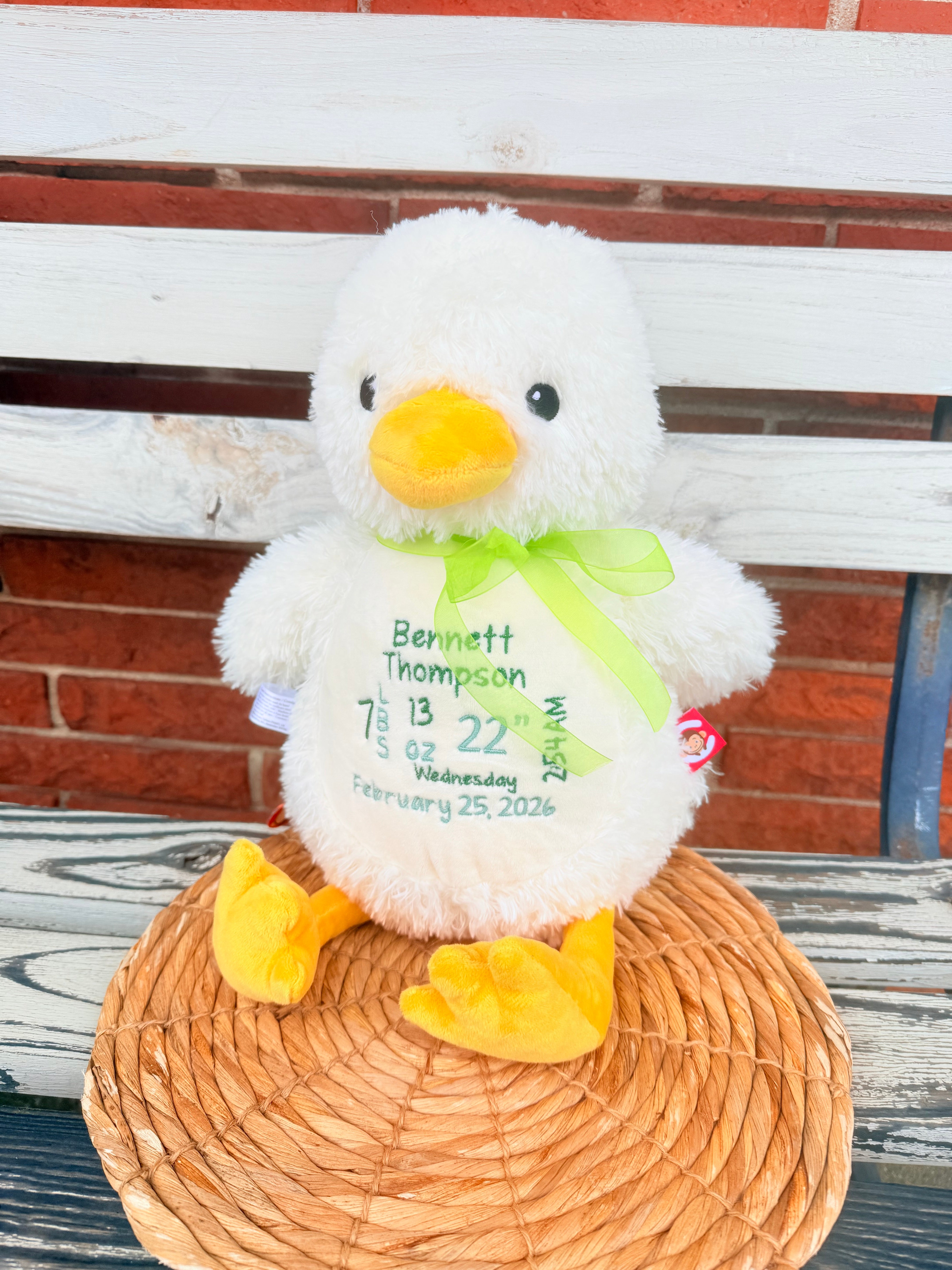 Plush toy with a personalized message on a wooden surface