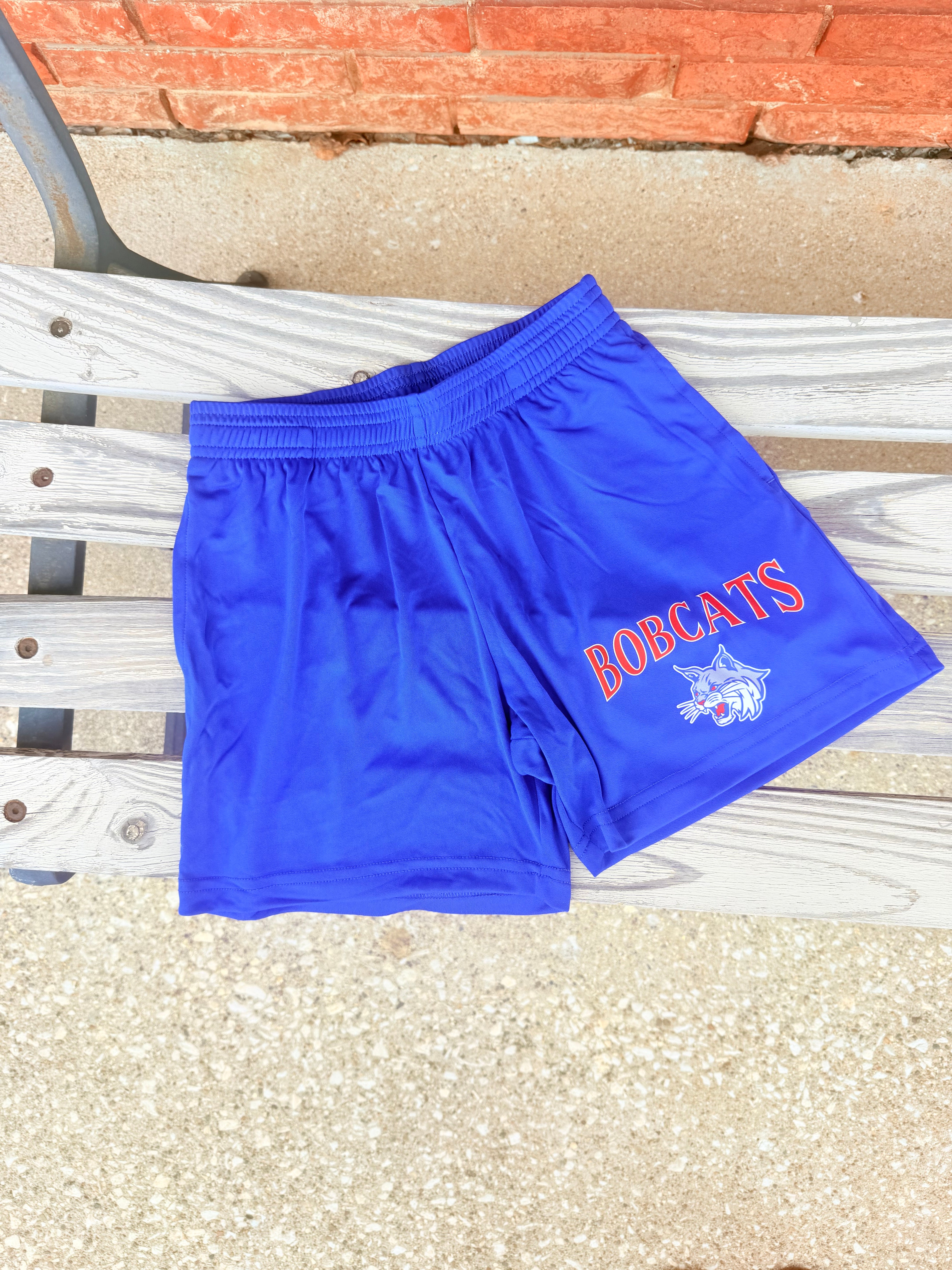 Blue athletic shorts with 'Bobcats' text.
