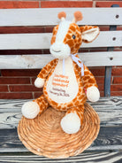 Plush giraffe on a bench