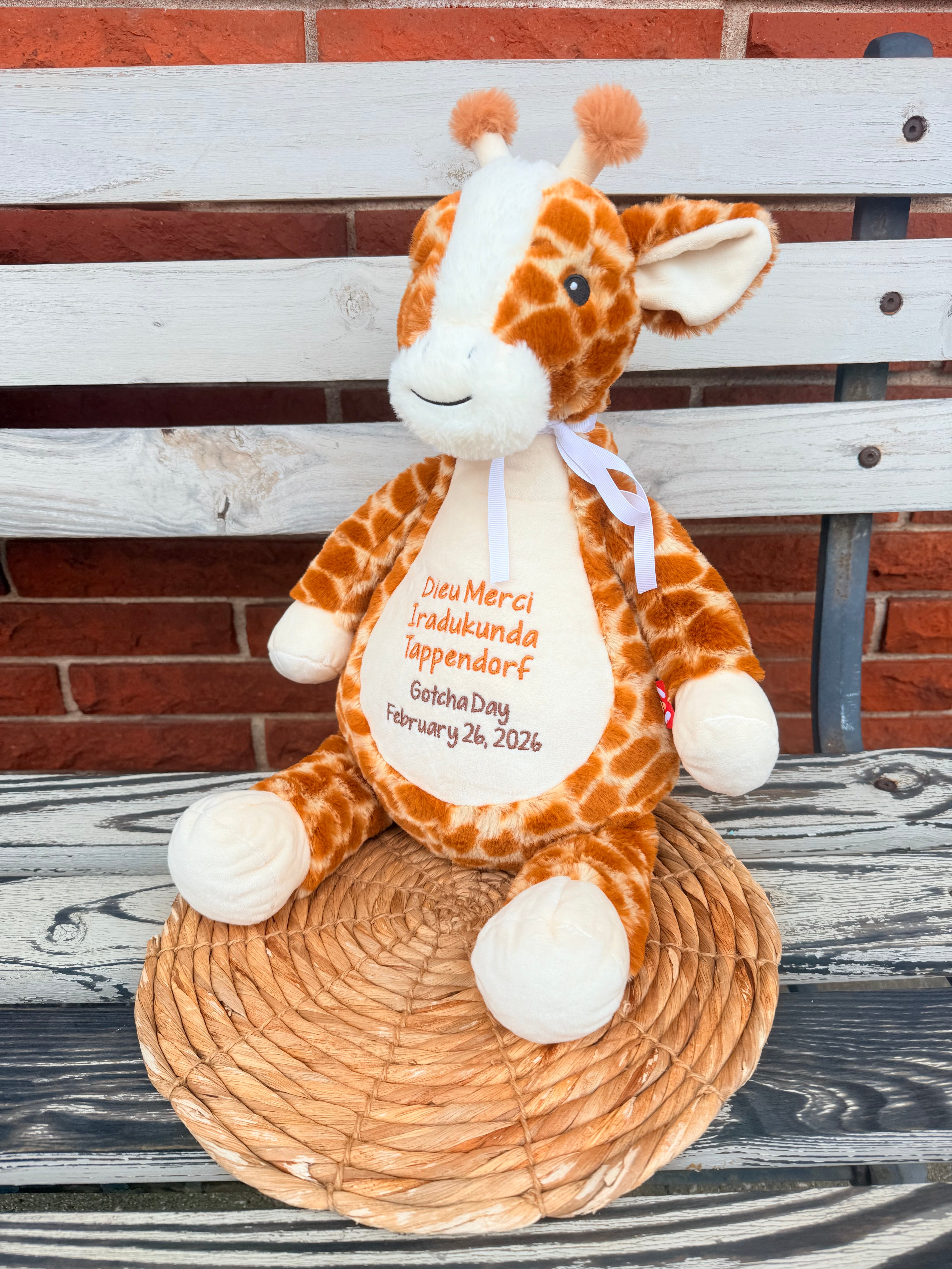 Plush giraffe on a bench