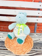 Plush toy with a message card on a wooden surface